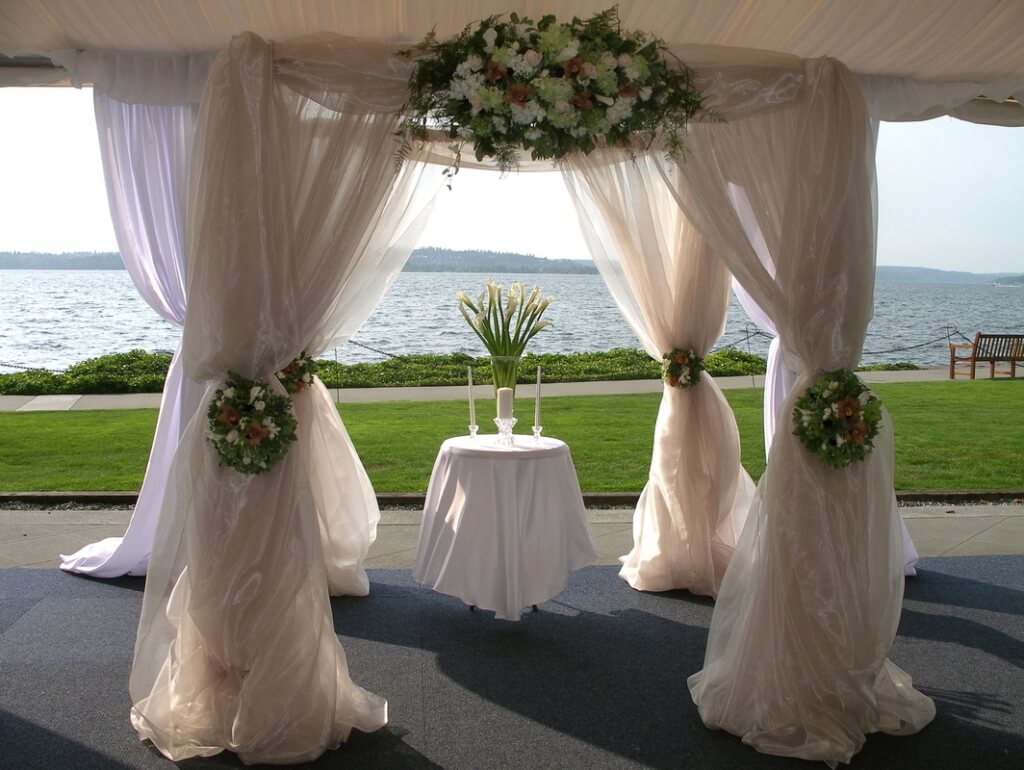 A Mode Events beautiful tent and draping with florals on the waterfront
