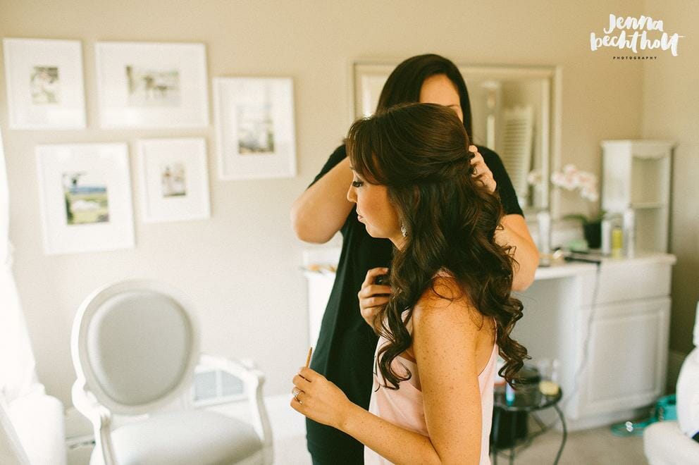 Bride getting hair and makeup done for ceremony
