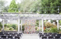 Wedding ceremony setup at Graham Visitor Center with a backdrop of colorful hanging paper origami swans